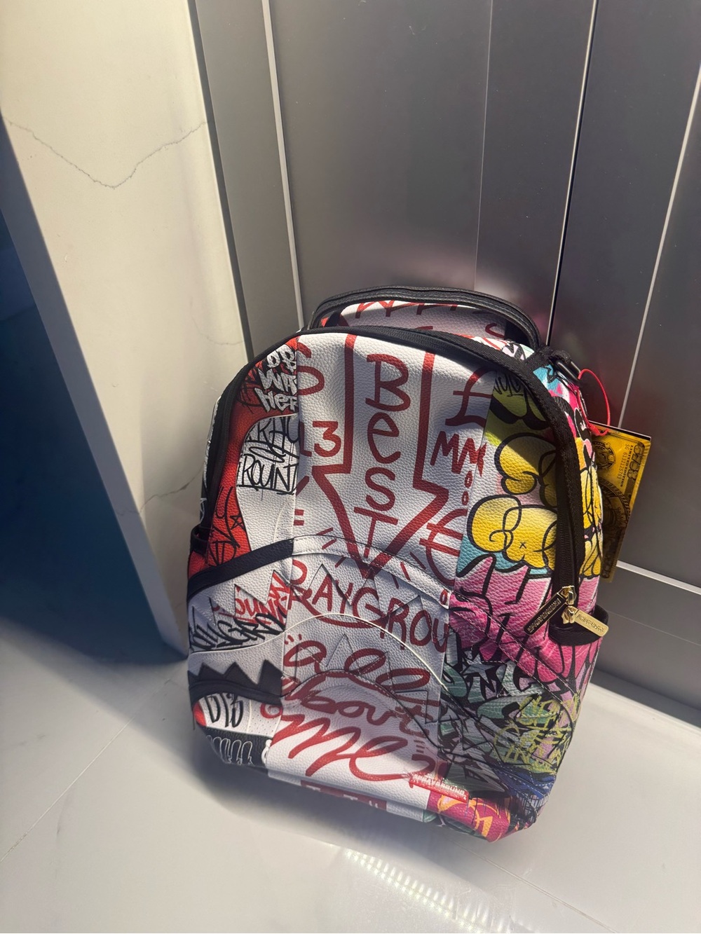 Sprayground Colorful Graffiti Sling Backpack in Red, Yellow, Pink, Black